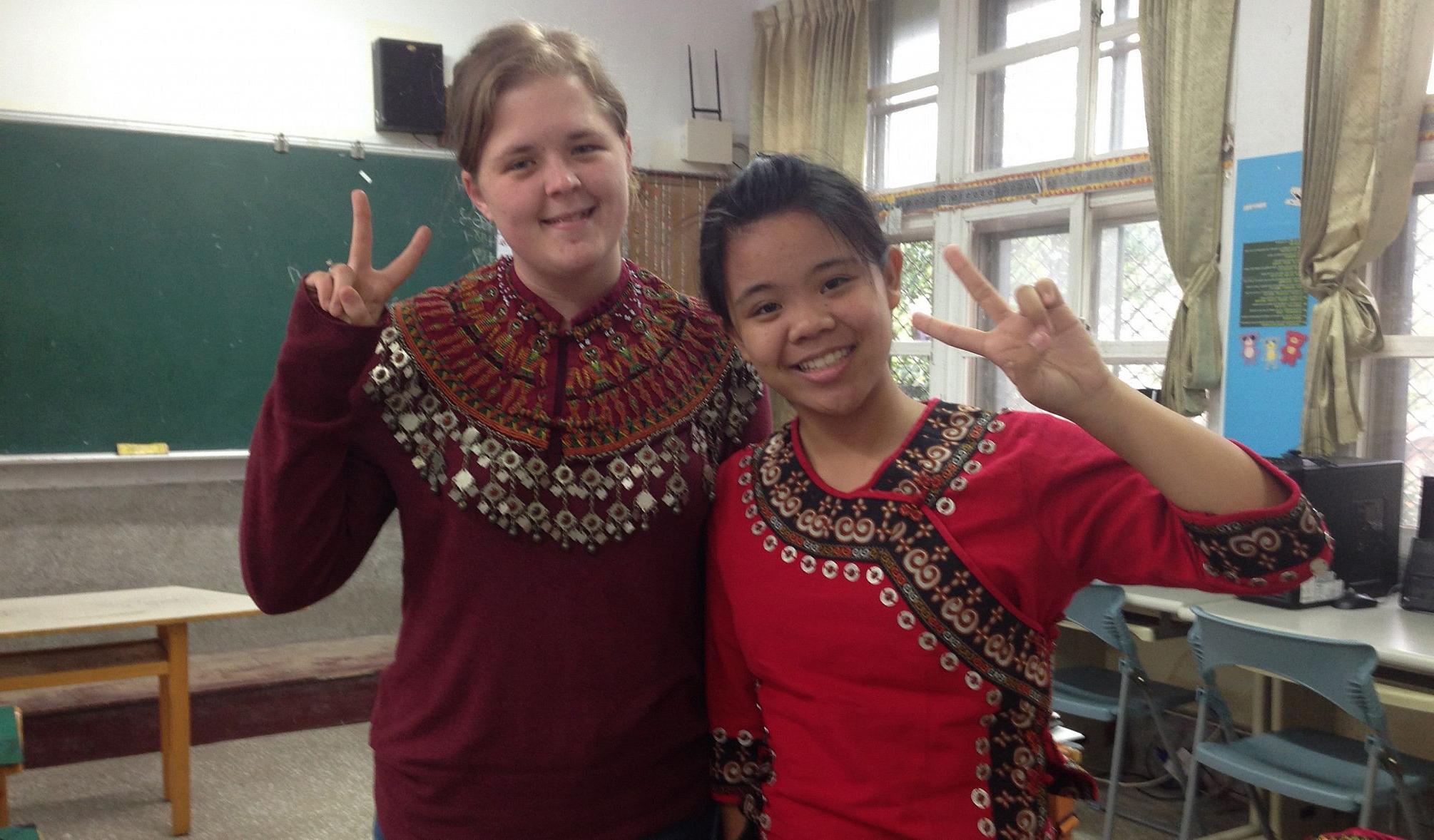 Jessie Bingaman '16 dons a traditional Paiwan collar, with her sixth-grade student Annie, in traditional clothing, as a Fulbright English...