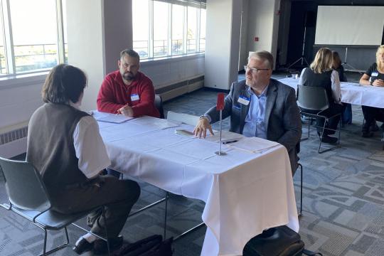 Two community members hold a mock interview for a Carthage education student.